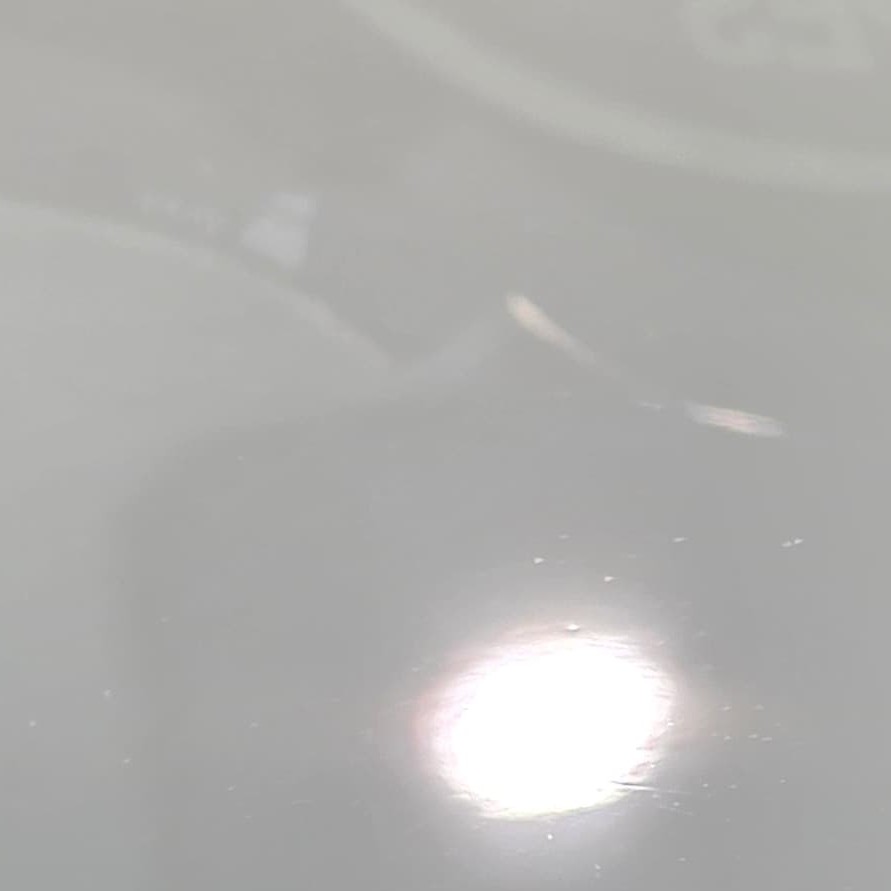 Audi Q3 silver metallic paint with severe rotary buffer holograms and dense swirl marks under inspection light before correction at JETWASH